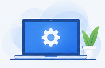 Laptop displaying a settings gear beside a plant